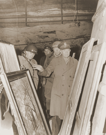 General Dwight D. Eisenhower, Supreme Allied Commander in the West, accompanied by General Omar Bradley, (left), and Lt. General George S. Patton, inspect stolen art treasures hidden in the Merkers salt mine.