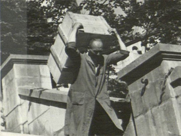 ERR depot of Neuschwanstein, Germany—Worker carrying crate of looted cultural property on his shoulders for loading onto a truck headed for the ERR art repository codenamed “Lager Peter” in the salt mines about Altaussee, Austria, 12 June 1944.