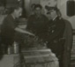 Paris, France.  SS Colonel von Behr, chief of the Dienststelle Westen for the ERR in Paris inspecting items being crated.  Note partitioned spaces in the background where looted objects are sorted and displayed.