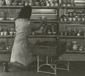 Paris, France. Female employee at a M-Aktion camp neatly arranging chinaware looted from Jewish apartments during Möbel-Aktion prior to its crating and shipment to Germany.